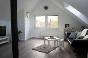 a living room with a couch and a table at Zentrale Ferienwohnung in Bielefeld