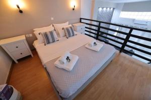 a bedroom with a large bed with towels on it at loft apartment in Athens