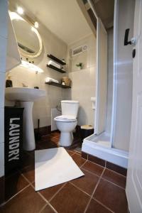a bathroom with a toilet and a sink and a shower at loft apartment in Athens