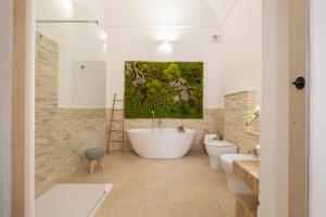 a bathroom with two toilets and a large painting on the wall at Via Roma 106 Apartment in Sassari +103 photos