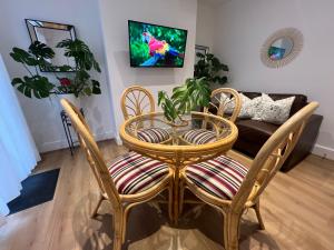 a living room with a table and chairs and a couch at 2025 Award Winner Liverpool Cherry House - 4 Bedrooms in Liverpool