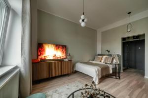 Ένα ή περισσότερα κρεβάτια σε δωμάτιο στο Oliwkowy Apartament