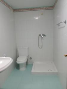 a white bathroom with a toilet and a sink at Monroser in Tremp +83 photos