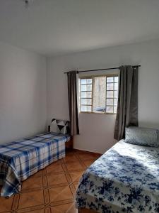 Ένα ή περισσότερα κρεβάτια σε δωμάτιο στο 2 Camas de Solteiro SOBRADO