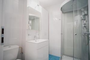 a white bathroom with a sink and a shower at SEB Residence Sibiu II in Sibiu