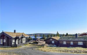 a group of houses with trees and mountains in the background at Sjusjøen Setergrend 4724 B in Sjusjøen
