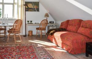 a living room with a couch and a table and chairs at Beautiful Home In Dalby With 2 Bedrooms And Wifi in Dalby