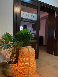 an orange suitcase sitting in front of a hotel lobby at Hotel Restauracja Cztery Pory Roku in Orneta +28 photos