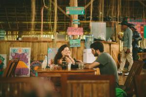 a man and a woman sitting at a table at Wonderland in Siquijor