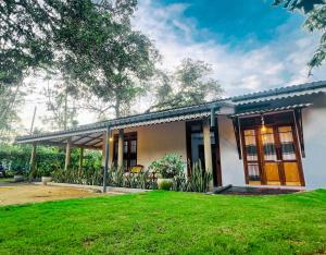 a house with a green lawn in front of it at 11 11 Weligama in Weligama