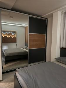 a bedroom with a large sliding glass door with a bed at Duspara lux apartment Jahorina in Jahorina