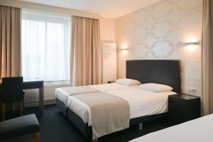 Postel nebo postele na pokoji v ubytování Hotel Essenza
