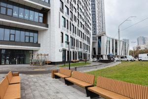 a group of benches in front of a building at Nyvky Like Home - Manchattan City - Квартира 290-2 in Kyiv