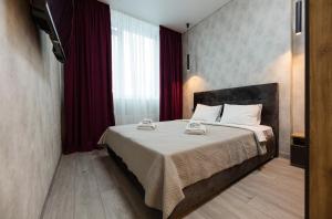a bedroom with a large bed with red curtains at Nyvky Like Home - Manchattan City - Квартира 290-2 in Kyiv