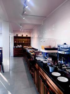 a kitchen with a long counter with food on it at Hotel Zagonel in Chapecó