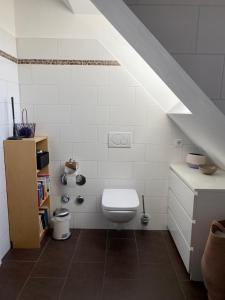 a bathroom with a white toilet in a attic at Helle und ruhige Dachgeschosswohnung in Munich