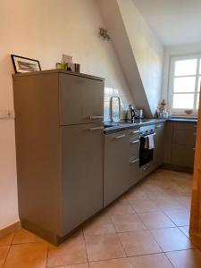 a kitchen with a stainless steel refrigerator and a stove at Helle und ruhige Dachgeschosswohnung in Munich +15 photos