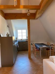 a kitchen and dining room with a table and a counter at Helle und ruhige Dachgeschosswohnung in Munich