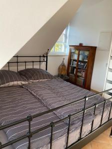 a large bed in a room with a staircase at Helle und ruhige Dachgeschosswohnung in Munich