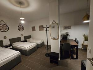 a room with two beds and a table with a mirror at ApartHotel Slumber in Geesthacht +11 photos