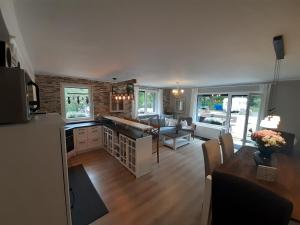 a kitchen and living room with a couch and a table at Harz-Forest-Inn in Goslar