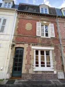 トゥルヴィル・シュル・メールにあるMaison de pêcheursの窓とドアが2つある古いレンガ造りの建物