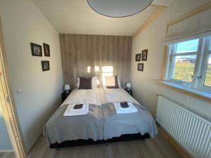a bedroom with a large bed in a room at Cozy Little Cottage In The Golden Circle no01 in Mosfellsbær