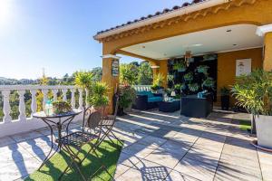 a patio with a table and chairs on a balcony at Charmante Maison de village- les adrets in Les Adrets de l'Esterel