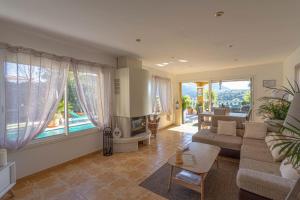 a living room with a couch and a table at Charmante Maison de village- les adrets in Les Adrets de l'Esterel +6 photos