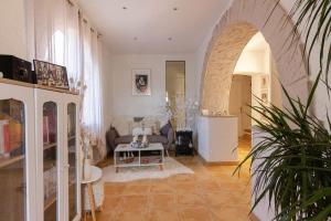 a living room with a couch and a table at Charmante Maison de village- les adrets in Les Adrets de l'Esterel