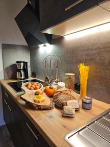 a kitchen with a counter with food on it at ALPENCHALET LENGAU im Bergsteigerdorf Ginzling Dornauberg in Dornauberg