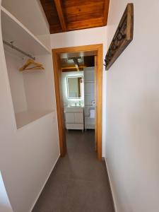 a hallway leading to a bathroom in a house at Quinta das Rosas 6 Amaizing Seaview Trekking Beach in Estreito da Calheta