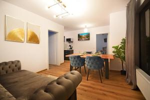 a living room with a table and a couch at Grand View Slanic Moldova in Slănic-Moldova