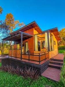 a home with a large porch and a deck at Cabana Agatha - Alfredo Wagner SC in Barracão