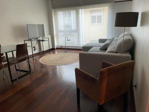 a living room with a couch and a table at Apartamento Arrabida in Lisbon