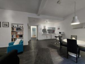 a living room with a table and a blue chair at Le FOURNIRUE T2 in Metz