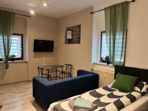 a living room with a blue couch and a table at LENASTAY I City Comfort Apartment in Top Location in Kaiserslautern
