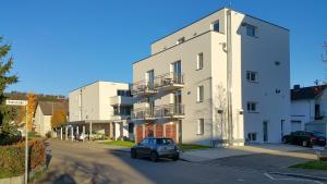 a car parked in front of a white building at Hotel Go2Bed Weil am Rhein - Basel in Weil am Rhein