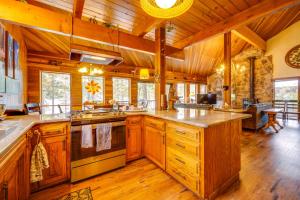 a large kitchen with wooden floors and wooden ceilings at Waterfront Truckee Cabin on Donner Lake! in Truckee