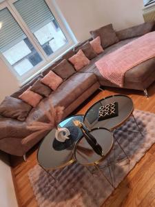 a living room with two tables and a couch at Bienvenue chez Angèle Homes 1 in Niederbronn-les-Bains