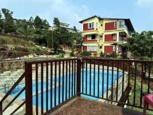 a balcony with a view of a swimming pool at Vinayaka Stays - Infinity Pool and Breathtaking Valley View in Panchgani