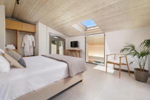 a bedroom with a large bed and a skylight at My Mediterranean Luxury Villas,Corfu in Kontokali +79 photos