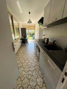 a kitchen with a sink and a counter top at L'Olivette in Aubenas