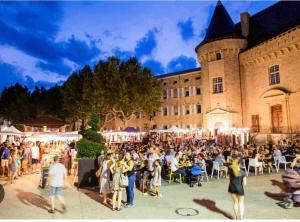 a crowd of people standing in front of a building at L'Olivette in Aubenas +24 photos
