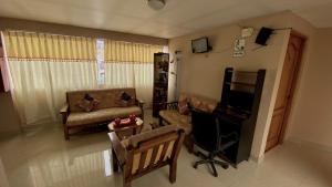 a living room with a couch and a chair at Casona Plaza Hotel Centro in Puno
