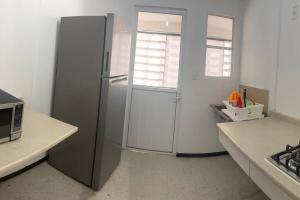a kitchen with a stainless steel refrigerator in a kitchen at Departamento Práctico Facturamos in San Carlos