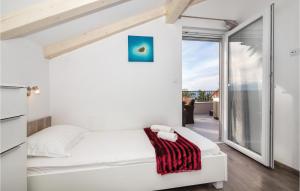 a bedroom with a white bed and a balcony at Three-Bedroom Holiday Home In Suhi Potok in Jesenice