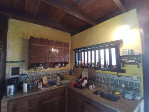 a kitchen with a sink and a counter top at Lindo casarão assobradado no centro de Itaúnas in Conceição da Barra