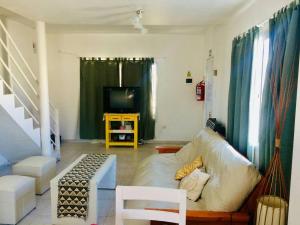 a living room with a couch and a television at Moana II in Las Grutas