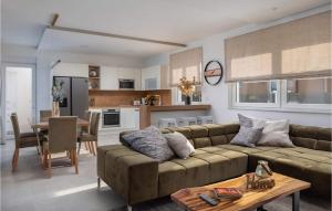 a living room with a couch and a table at Villa Katarina Privlaka in Privlaka